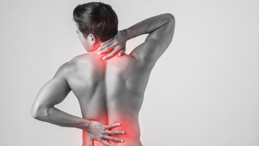 Man holding neck and lower back with red pain zones highlighted