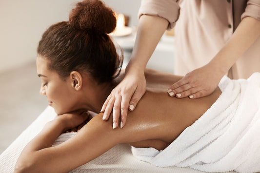 A woman gets a massage while lying on a table.